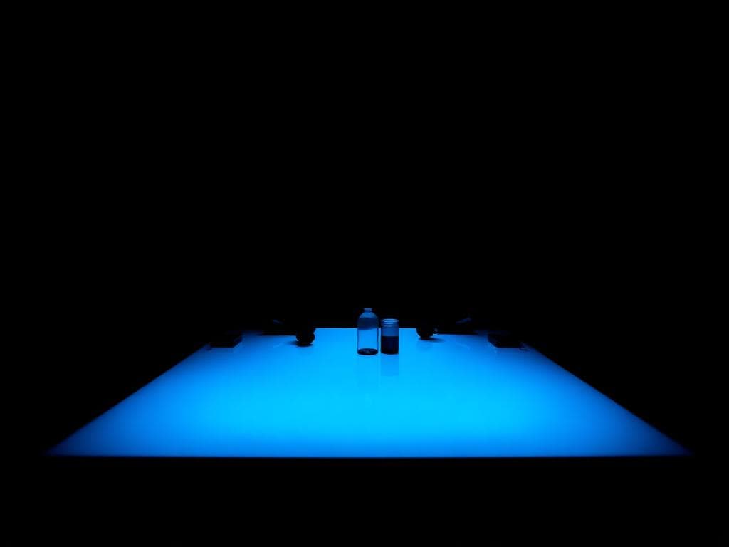 Team in discussion around a lit table